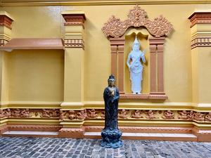 Statues on a Yellow Wall
