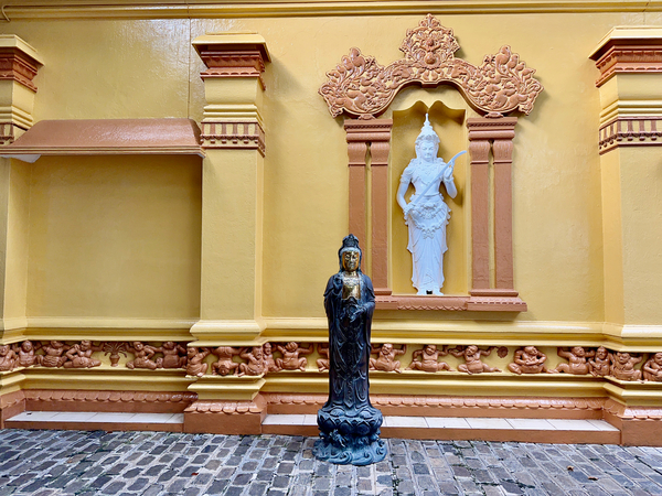 Statues on a Yellow Wall Print